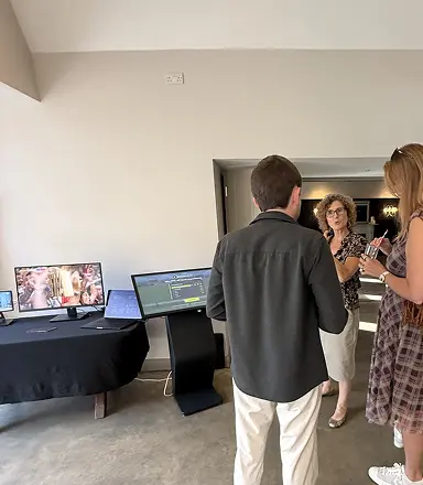 Guests interacting with the game screen at the corporate event venue