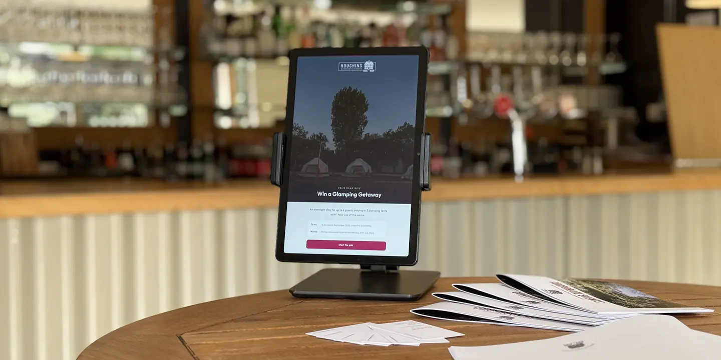 Win a Glamping Getaway competition tablet display at the bar