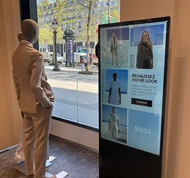 Digital kiosk with mannequin in the Paris store window