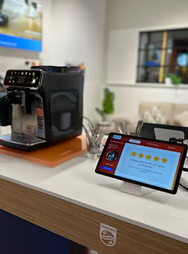 Espresso machine kiosk with a five-star review screen