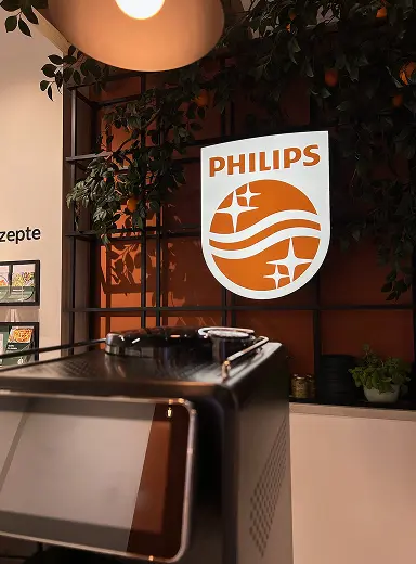 Illuminated Philips logo sign in a kitchen appliance showroom
