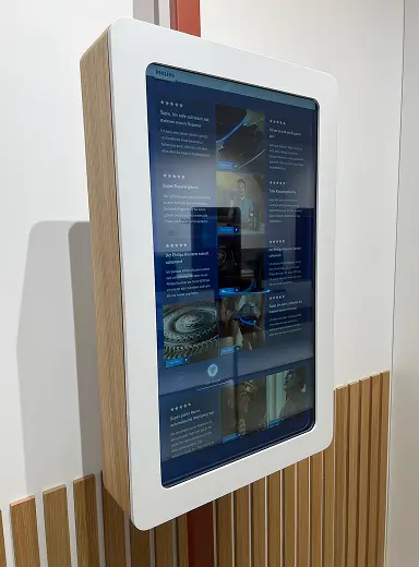 Wall-mounted digital kiosk showing five-star customer reviews