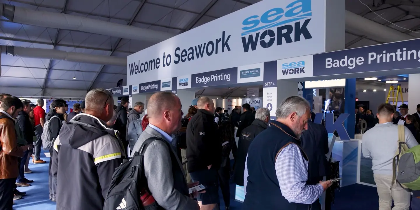 Crowd queuing at the Seawork Expo entrance and badge printing area