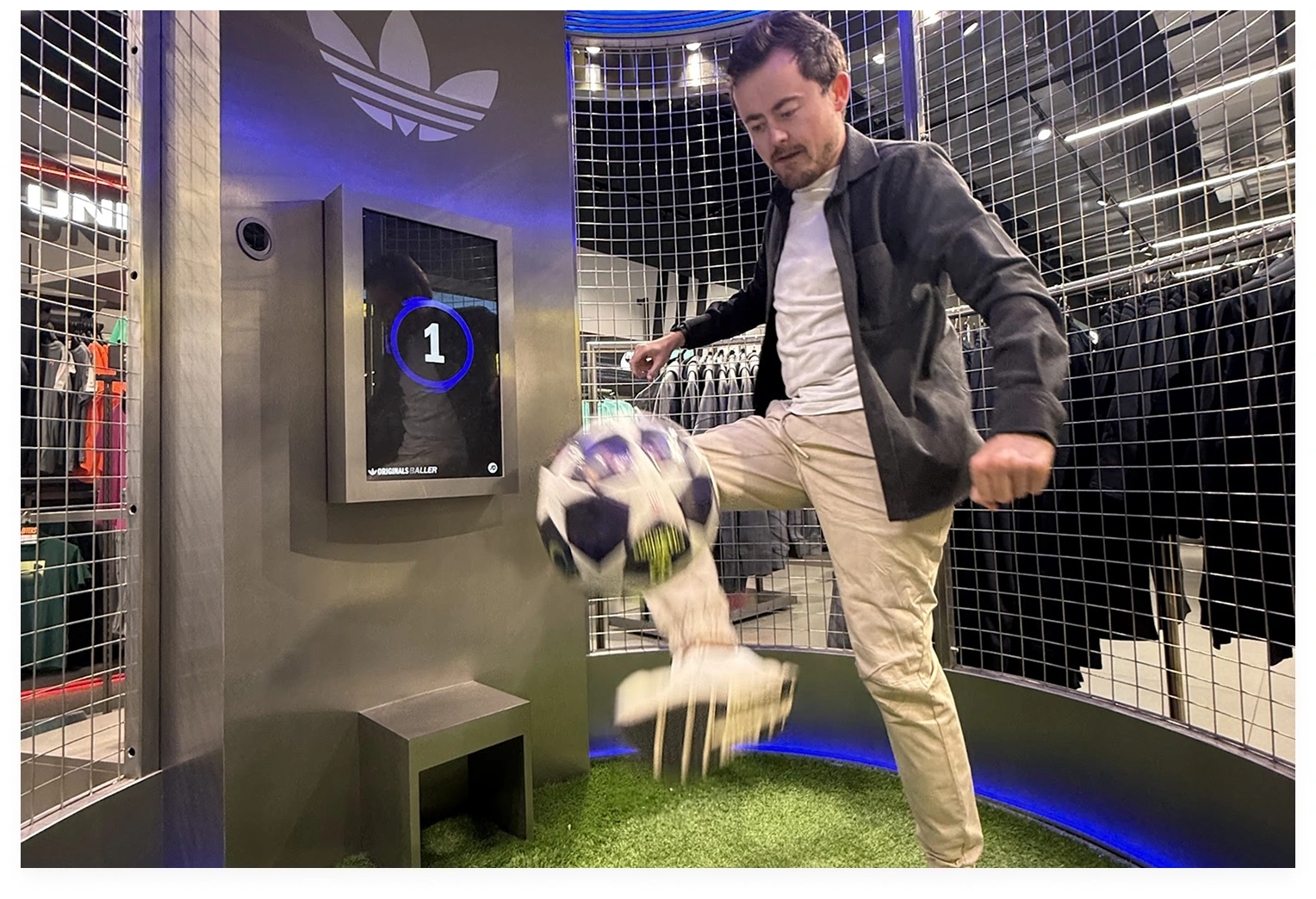 Person using an Adidas soccer kiosk in store